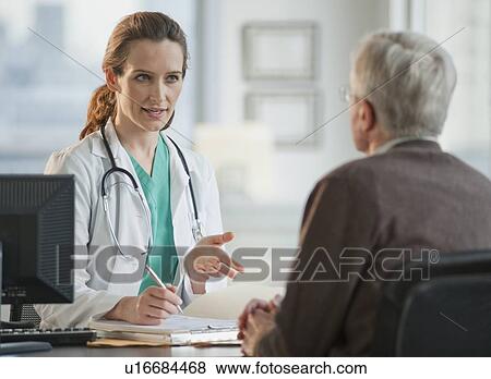 Doctor consulting with senior man View Large Photo Image Stock Photo - Doctor consulting with senior man. Fotosearch