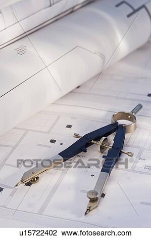 Stock Image - Drawing compass and blueprints. Fotosearch