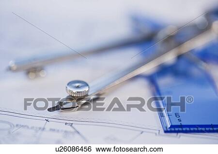 Stock Photograph - Drawing compass and blueprints. Fotosearch