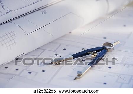 Stock Photography - Drawing compass and blueprints. Fotosearch