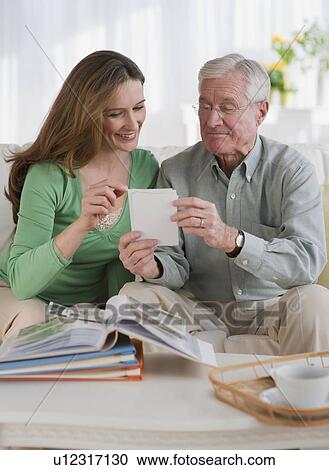 Father an daughter looking at photo albums View Large Photo Image Stock Image - Father an daughter looking at photo albums. Fotosearch