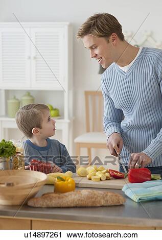 Father and son cooking dinner View Large Photo Image Stock Image - Father and son cooking dinner. Fotosearch