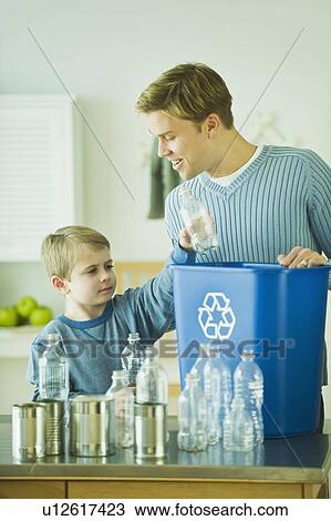Stock Image - Father and son recycling. Fotosearch