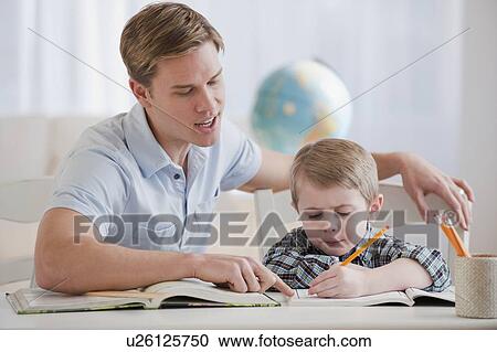 Stock Image - Father helping son with homework. Fotosearch
