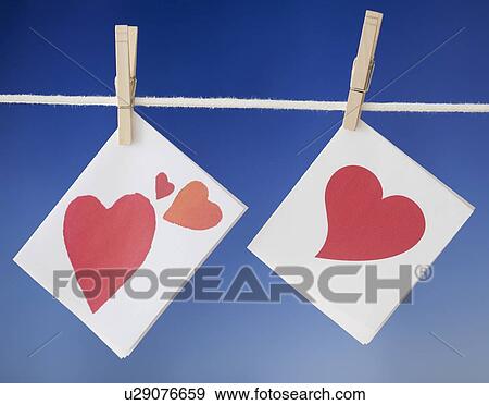 Stock Photo - Felt heart drying on clothesline. Fotosearch