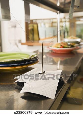 Food order spike in restaurant kitchen View Large Photo Image Stock Photograph - Food order spike in restaurant kitchen. Fotosearch