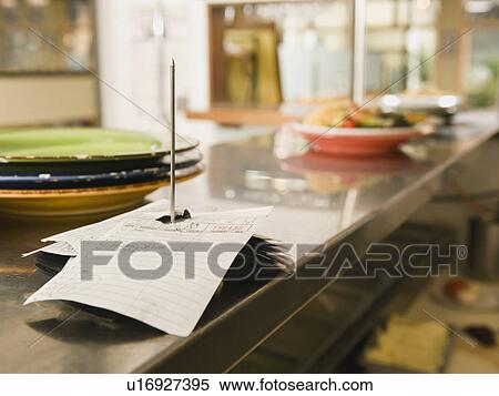 Stock Photography - Food order spike in restaurant kitchen. Fotosearch