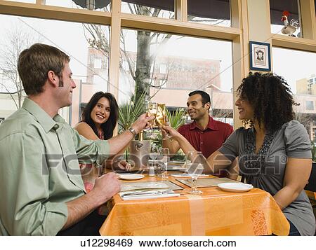 Friends toasting in restaurant View Large Photo Image Stock Photo - Friends toasting in restaurant. Fotosearch