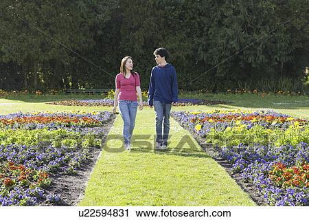 Friends walking in garden View Large Photo Image Stock Image - Friends walking in garden. Fotosearch