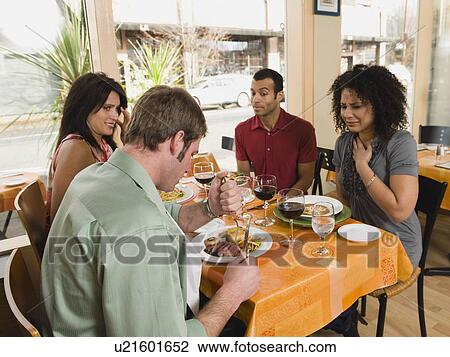 Friends watching man cut steak in restaurant View Large Photo Image Stock Image - Friends watching man cut steak in restaurant. Fotosearch