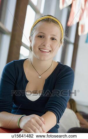 Stock Image - Girl posing in library. Fotosearch