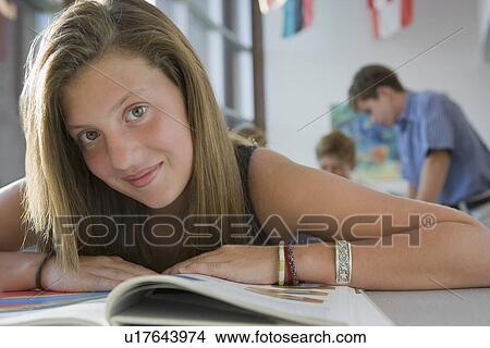 Picture - Girl reading in library. Fotosearch