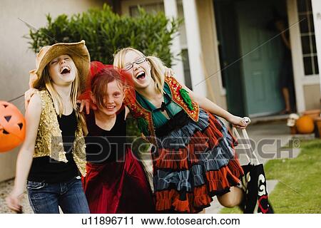Girls trick or treating View Large Photo Image Stock Image - Girls trick or treating. Fotosearch