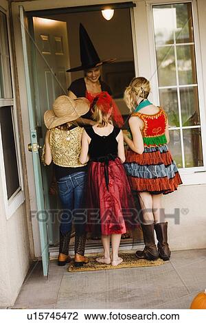 Girls trick or treating View Large Photo Image Stock Image - Girls trick or treating. Fotosearch