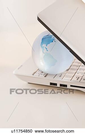 Globe inside laptop View Large Photo Image Stock Image - Globe inside laptop. Fotosearch