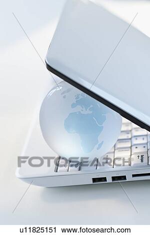 Stock Image - Globe inside laptop. Fotosearch