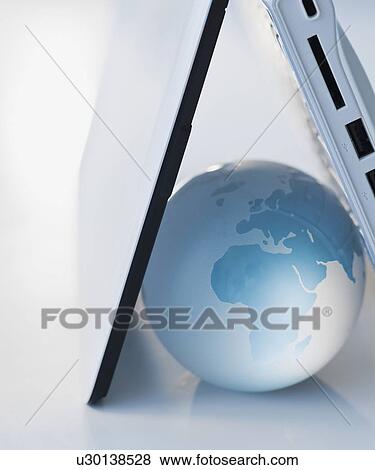 Stock Photo - Globe inside laptop. Fotosearch