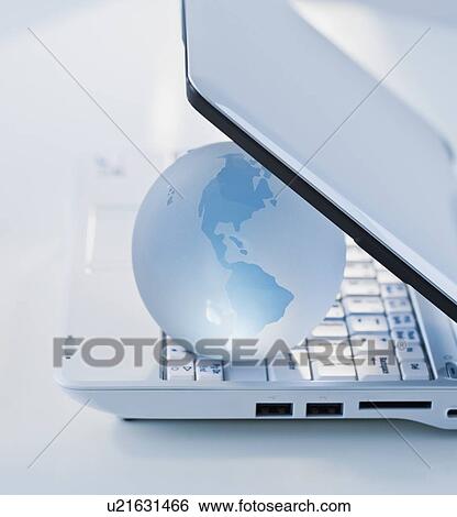 Globe inside laptop View Large Photo Image Stock Photograph - Globe inside laptop. Fotosearch