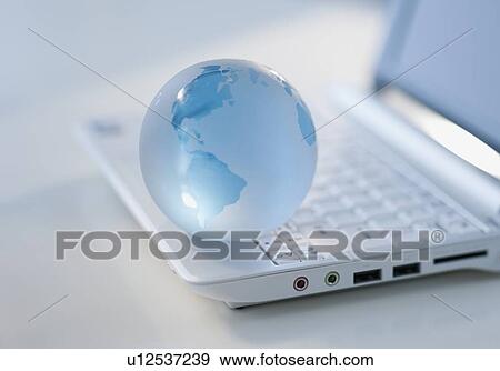 Globe on laptop keyboard View Large Photo Image Stock Photo - Globe on laptop keyboard. Fotosearch