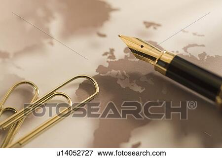Stock Photo - Gold paper clips and pen. Fotosearch