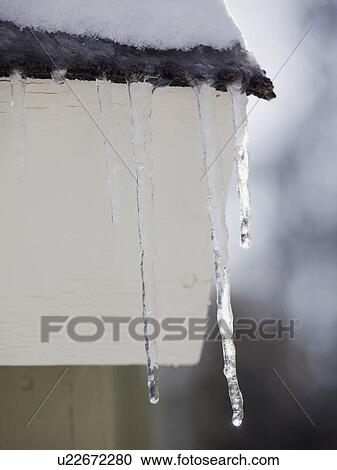 Icicles hanging from roof eaves View Large Photo Image Stock Image - Icicles hanging from roof eaves. Fotosearch