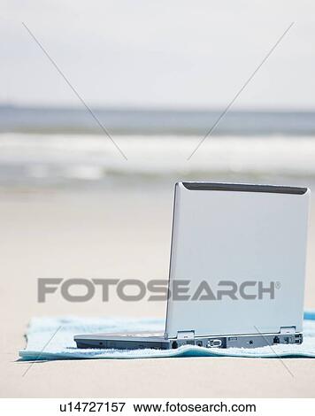 Stock Photo - Laptop on beach. Fotosearch