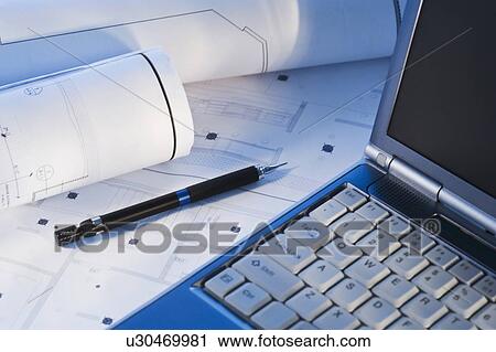 Stock Image - Laptop on blueprints. Fotosearch