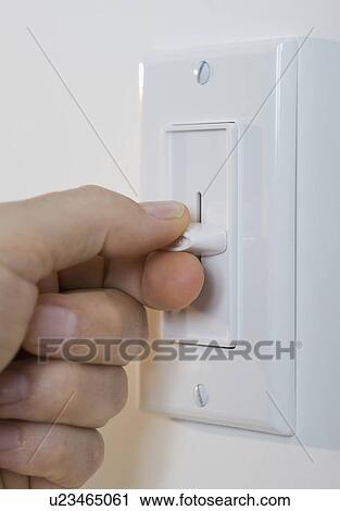 Man adjusting light dimmer View Large Photo Image Stock Image - Man adjusting light dimmer. Fotosearch