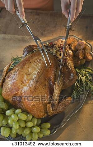 Man carving Thanksgiving turkey View Large Photo Image Stock Image - Man carving Thanksgiving turkey. Fotosearch