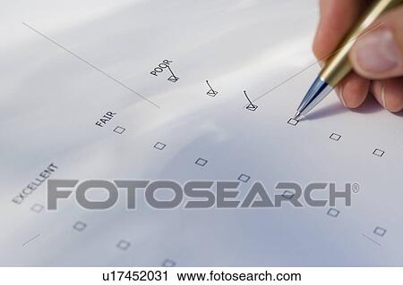 Stock Image - Man checking rating boxes. Fotosearch