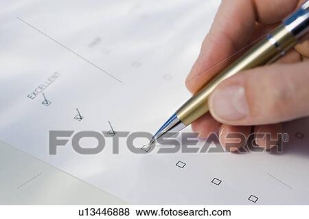 Stock Photo - Man checking rating boxes. Fotosearch