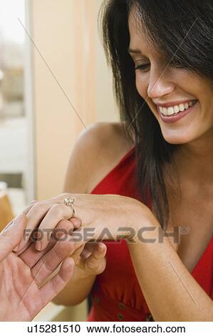Man giving girlfriend engagement ring in restaurant View Large Photo Image Stock Image - Man giving girlfriend engagement ring in restaurant. Fotosearch