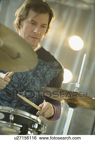 Man playing drums View Large Photo Image Stock Photograph - Man playing drums. Fotosearch