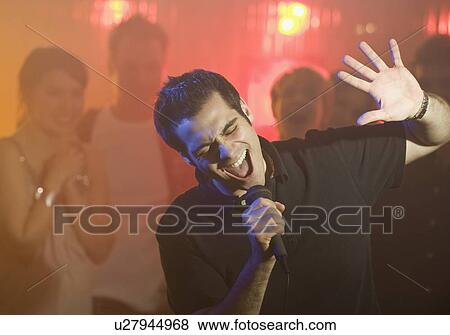 Man singing karaoke View Large Photo Image Stock Photo - Man singing karaoke. Fotosearch