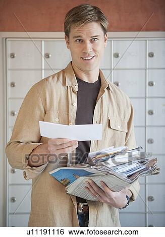 Stock Photograph - Man sorting stack of mail. Fotosearch