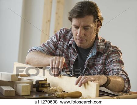 Stock Photo - Man using woodworking tools. Fotosearch