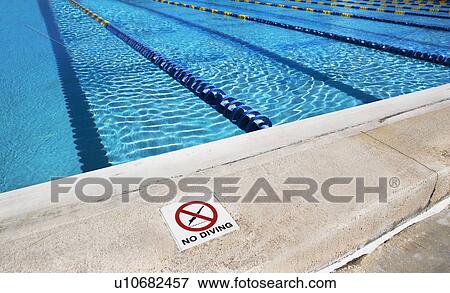 Stock Photo - No diving sign on edge of swimming pool. Fotosearch