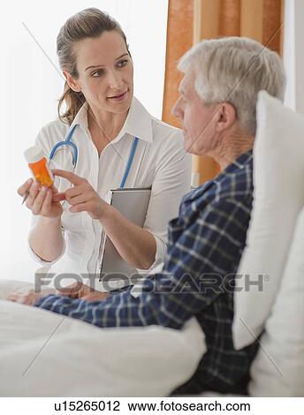 Nurse explaining prescription to senior man View Large Photo Image Stock Image - Nurse explaining prescription to senior man. Fotosearch