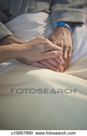 Nurse holding elderly man’s hand View Large Photo Image Stock Image - Nurse holding elderly man’s hand. Fotosearch