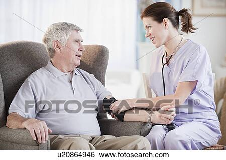Stock Photograph - Nurse taking senior man’s blood pressure. Fotosearch