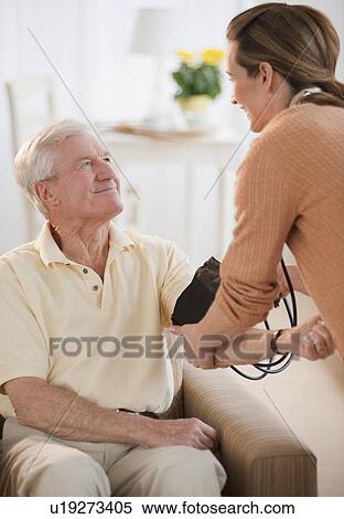 Nurse taking senior man’s blood pressure View Large Photo Image Stock Photography - Nurse taking senior man’s blood pressure. Fotosearch
