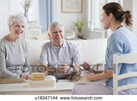 Picture - Nurse talking to senior adults. Fotosearch