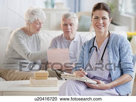 Stock Image - Nurse with senior adults. Fotosearch