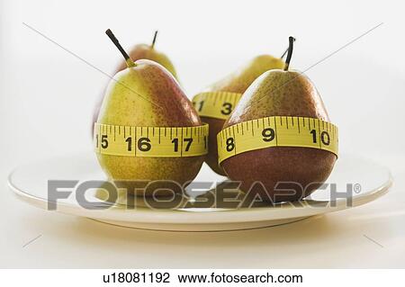 Pears wrapped in tape measures View Large Photo Image Stock Image - Pears wrapped in tape measures. Fotosearch