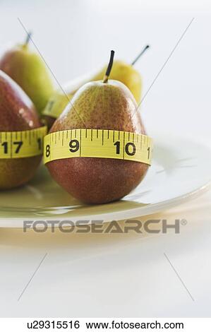Pears wrapped in tape measures View Large Photo Image Stock Photograph - Pears wrapped in tape measures. Fotosearch