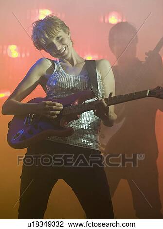 Performers playing electric guitars View Large Photo Image Stock Image - Performers playing electric guitars. Fotosearch