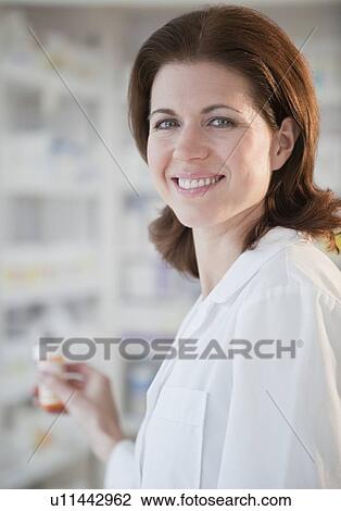Stock Image - Pharmacist filling prescription. Fotosearch
