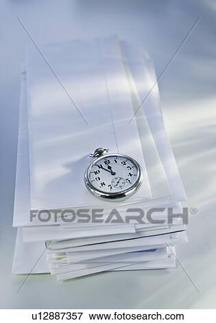 Pocket watch on stack of mail View Large Photo Image Stock Photo - Pocket watch on stack of mail. Fotosearch