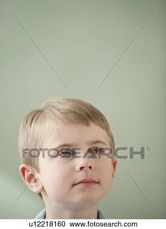 Stock Image - Portrait of boy looking up. Fotosearch