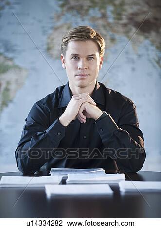 Stock Image - Portrait of businessman in office. Fotosearch